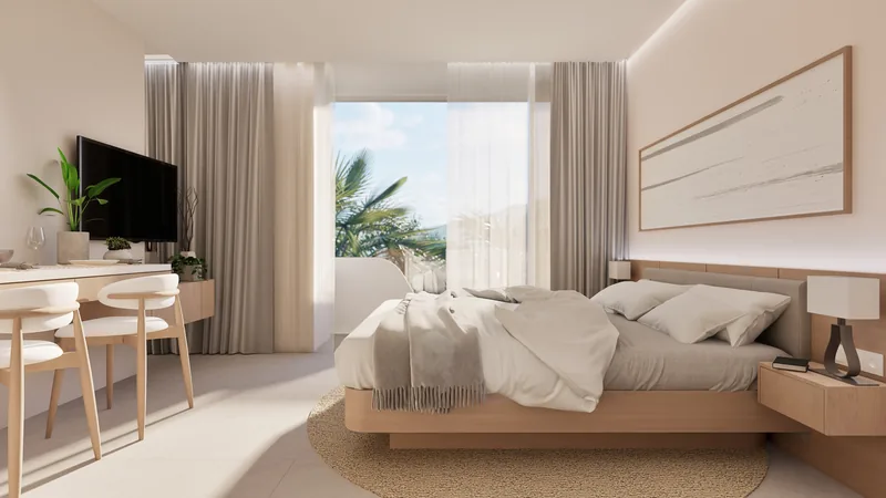 Studio interior at Millennium: bed, desk, floor-to-ceiling window